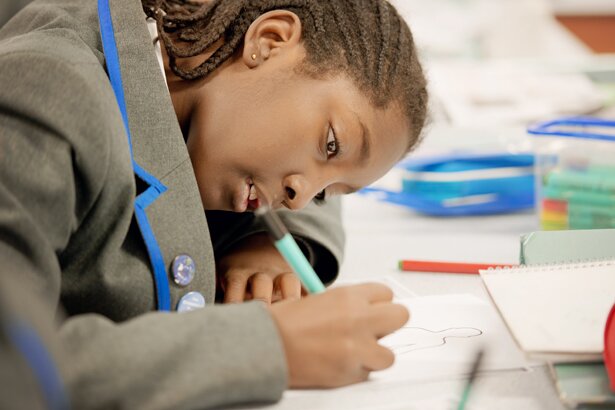 Picture of student writing in an exercise book